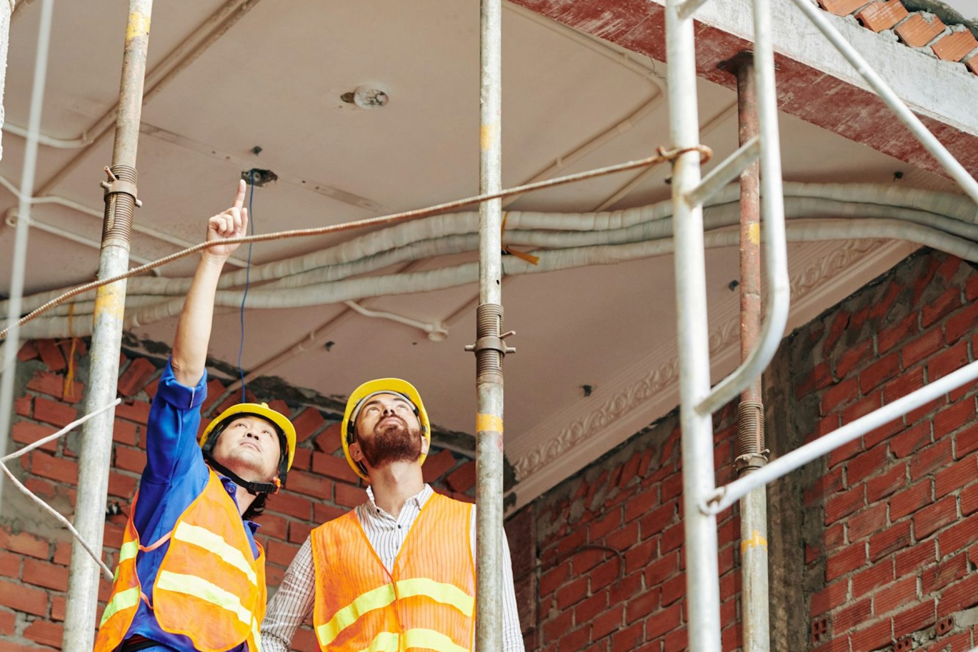 Builders discussing roof renovation